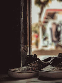 Close-up of shoes on window