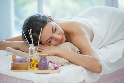 Woman lying on bed in spa