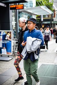 Friends standing on street in city