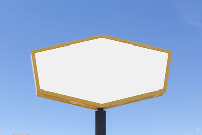 Low angle view of sign against clear blue sky