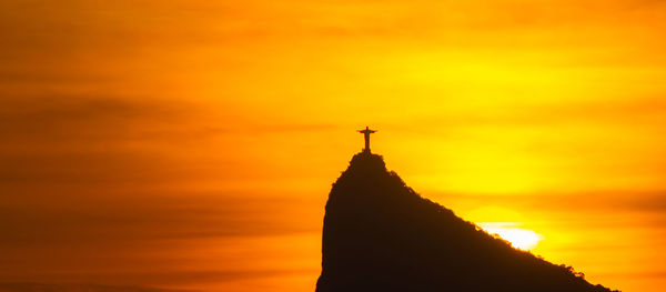 Silhouette of temple against sky during sunset