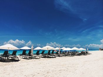 Scenic view of beach against blue sky