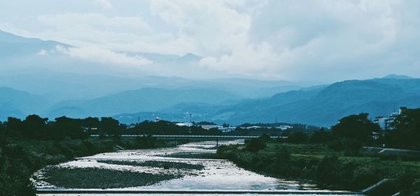 Scenic view of agricultural landscape against sky