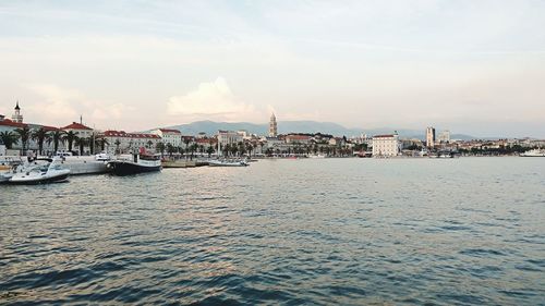 View of marina and buildings against sky