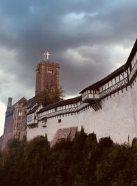 Low angle view of historical building against cloudy sky