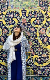 Woman standing against multi colored wall