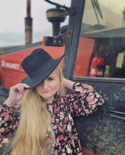 Portrait of young woman wearing hat