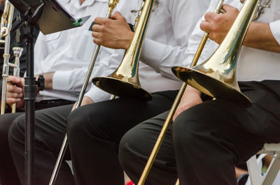 Midsection of people playing musical instruments