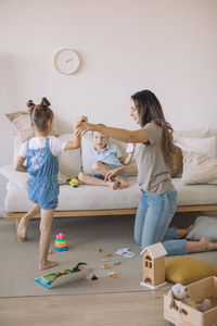 Rear view of people sitting on toy at home