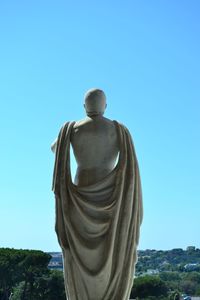 Low angle view of statue against clear blue sky