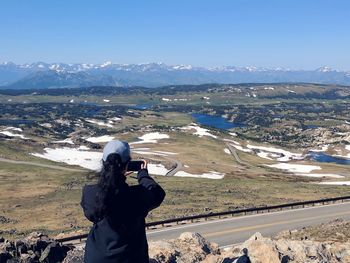 Female photographer viewing the alpine landscape of the scenic beartooth highway in wyoming
