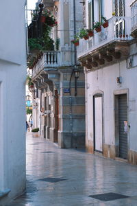 People walking on street amidst buildings in city