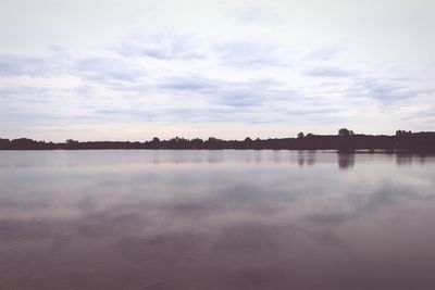 Scenic view of lake against cloudy sky