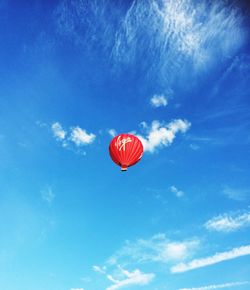 Low angle view of hot air balloon against blue sky