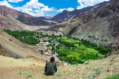 High angle view of woman by mountains against sky