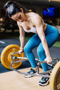 Young woman exercising in gym