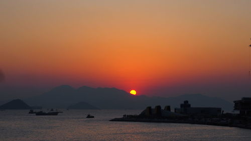 Scenic view of sea against romantic sky at sunset