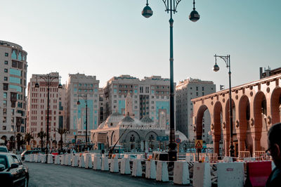 Street amidst buildings against clear sky