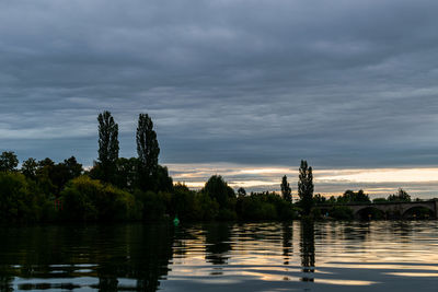 Scenic view of lake against sky at sunset