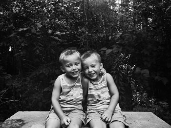 Portrait of smiling boy sitting outdoors