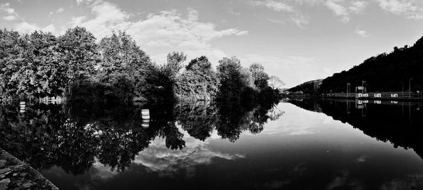 Reflection of trees in lake against sky