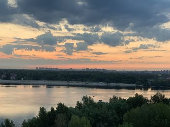 Scenic view of river against orange sky