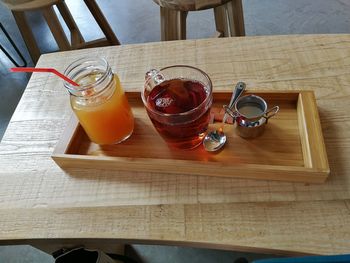 High angle view of drinks on wooden table