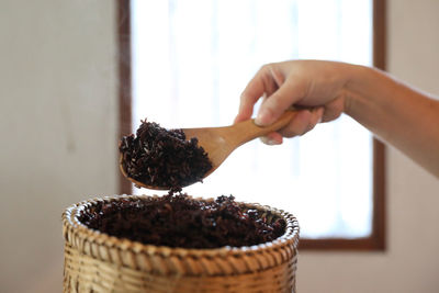 Midsection of woman holding ice cream in basket