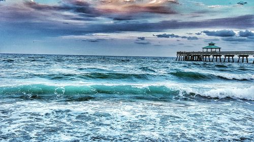 Scenic view of sea against cloudy sky