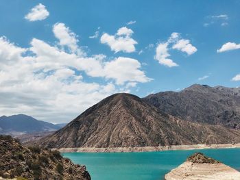 Scenic view of sea and mountains against sky