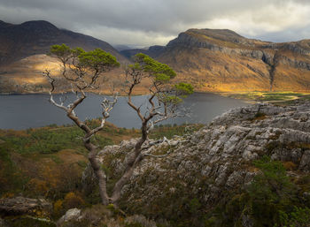 Scenic view of lake and mountains against sky