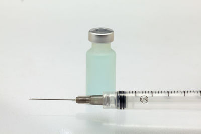 Close-up of bottle on table against white background