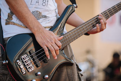 Close-up of man playing guitar