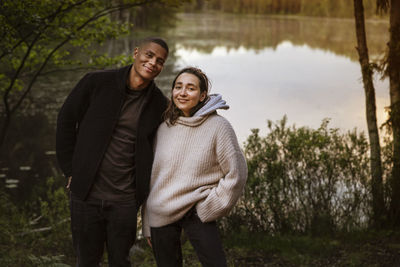 Portrait of young couple by lake