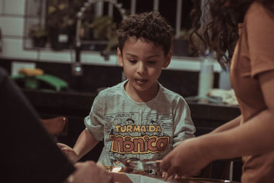 Portrait of young woman using mobile phone in cafe