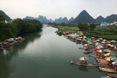 High angle view of people on river against mountains