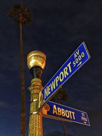 Low angle view of illuminated tower against sky at night