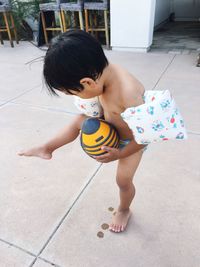 High angle view of baby playing with toy