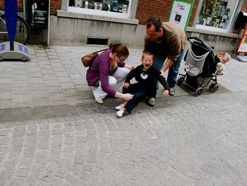 Full length of father and daughter on footpath