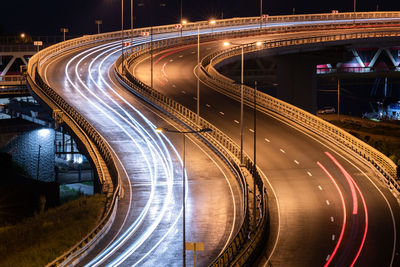 High angle view of light trails on highway at night