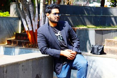 Portrait of young man sitting outdoors