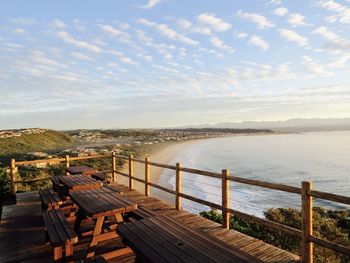 Scenic view of town and sea against sky during sunset seen from observation point