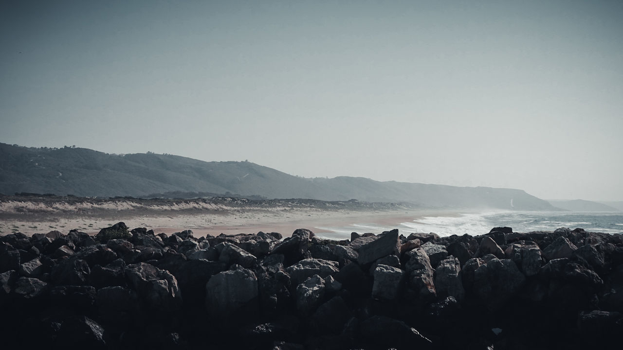 sky, mountain, clear sky, rock, tranquil scene, scenics - nature, beauty in nature, copy space, water, tranquility, nature, solid, rock - object, day, no people, land, non-urban scene, sea, mountain range, outdoors