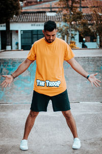 Portrait of young man exercising in city