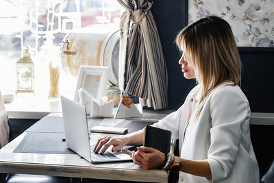 Young woman using laptop at home