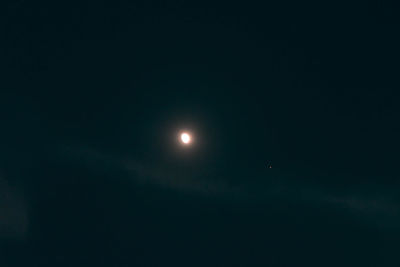 Low angle view of moon against sky at night