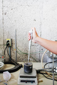 Cropped image of person performing experiment in chemistry laboratory