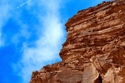 Low angle view of mountain against blue sky