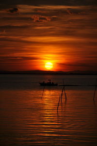 Scenic view of sea against orange sky