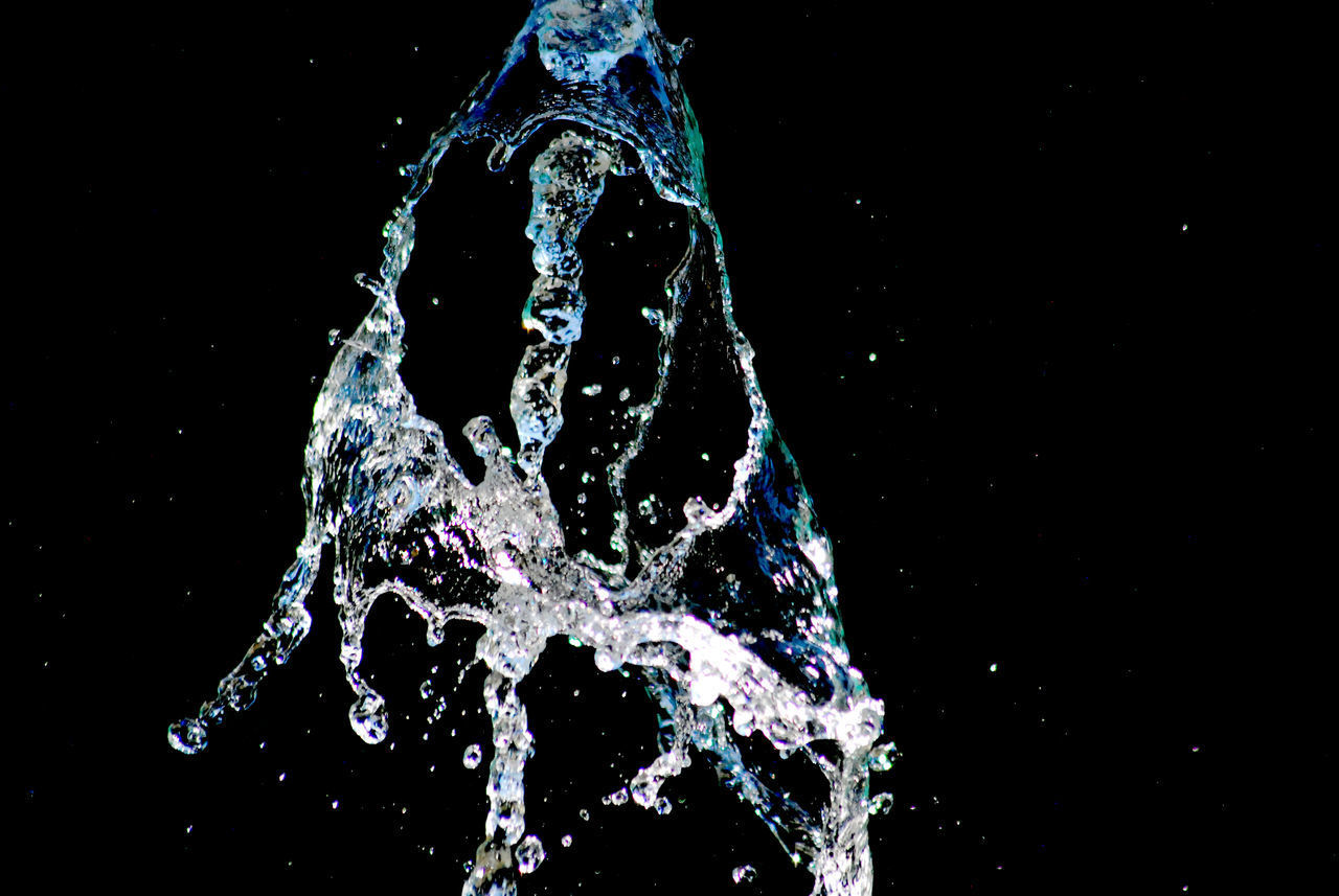 CLOSE-UP OF WATER DROP ON BLACK BACKGROUND